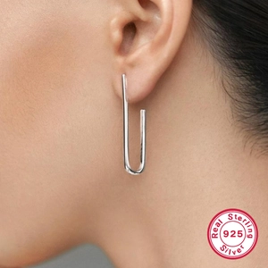 Elegant 925 sterling silver U-shaped drop earrings shown on model for minimalist style