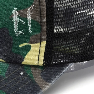 Close-up of distressed camo baseball cap with mesh back and vintage torn detail