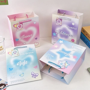 Pastel embossed paper gift bags with colorful rope handles in four gradient colors