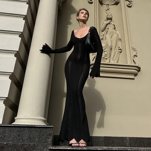 Close-up of black knitted maxi dress featuring hollow-out details and elegant fishtail hem