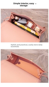 Detail view of the pink leather crossbody bag interior showing phone and makeup storage space