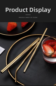Golden 304 stainless steel straw set with straight and curved pipes on black plate