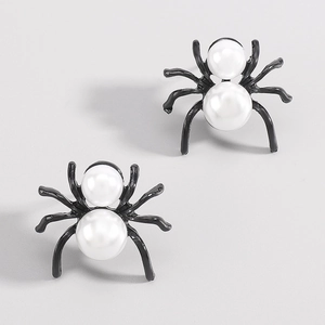 Macro view of gothic spider stud earrings with white faux pearls and black metal legs