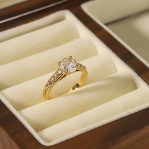 Luxury 18k gold plated stainless steel ring with four-prong zircon on velvet jewelry box