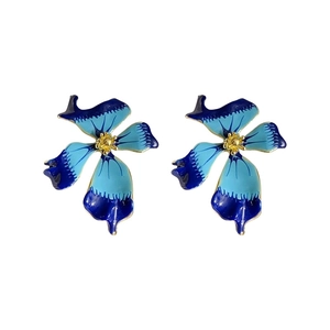 Vintage blue enamel flower stud earrings with gold accents in a minimalist style