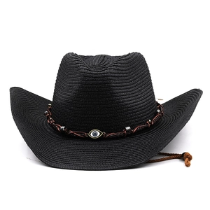 Close-up of black straw cowboy hat with evil eye bead and adjustable wind strap