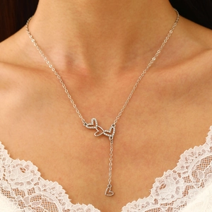 Detailed view of silver Y-shaped necklace featuring triple interlocking pavé heart pendants