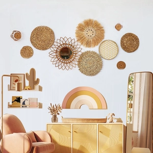 Detailed arrangement of Bohemian woven seagrass wall plates and rattan decor on a white wall