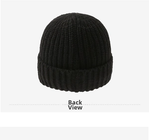 Detail view of the back of a black ribbed knit beanie featuring thick warming texture