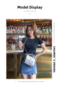 Fashionable white snake pattern flap crossbody bag with chain strap styled with denim skirt