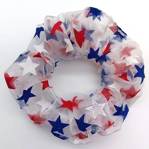 Mesh Christmas scrunchie with red white and blue star patterns on a white background