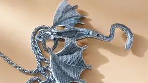 Detailed view of the vintage silver dragon pendant with a thick twisted rope chain necklace