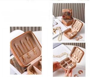 Detail view of portable leather jewelry box with necklace hooks and ring storage slots