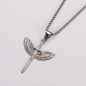 Detailed shot of silver stainless steel angel wings and sword pendant on a box chain