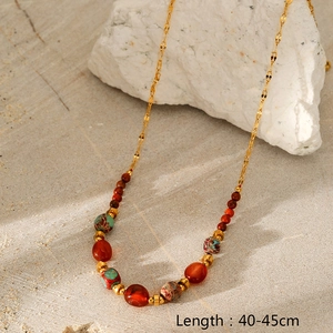 Detail of multi-layered stone beads on a gold-plated stainless steel chain necklace