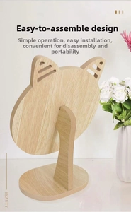 Detail of wooden cat-ear desktop vanity mirror featuring a stable oval base and stand