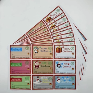 Close-up of assorted Christmas gift stickers with Santa and snowman designs on white background