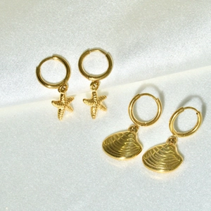 14K gold plated stainless steel hoop earrings with starfish and seashell charms on white silk