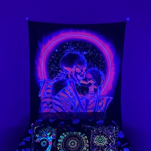 Detail of glow-in-the-dark tapestry featuring skeleton embrace and cosmic tree of life