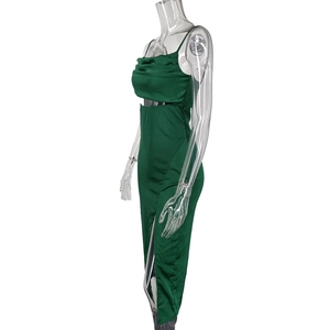 Detail of elegant dark green satin midi dress with side slit and waist cutout on mannequin
