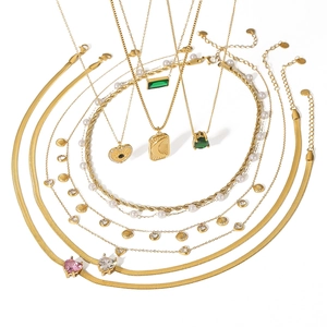 Layered gold stainless steel necklaces with sun, moon, pearl, and shell pendants