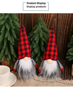 Detail of two Christmas gnomes with red and black buffalo plaid hats on burlap