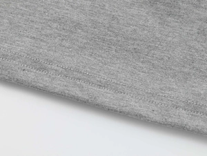 Detailed close-up of grey marl modal knit fabric and double-needle stitching on the hem