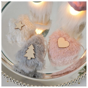 Close-up of fluffy heart and star plush Christmas ornaments with LED lights on a tray