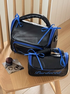 Waterproof ballet-style makeup bag set with blue ribbons and sleek black faux leather finish