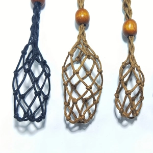 Detail of adjustable hand-woven mesh stone holders in black and brown with wood beads