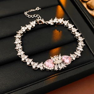 Close-up of silver bracelet featuring pink heart zircons and white marquise floral detail