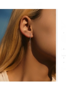Close-up of minimalist S925 sterling silver interlocking chain drop earrings on model