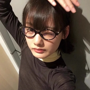 Y2K vintage oval black frame glasses for a retro geek chic style on a female model