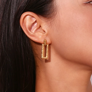 Minimalist 18K gold plated stainless steel earrings with geometric lava texture on model