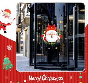 Detailed view of Christmas Santa Claus window stickers on a glass revolving door