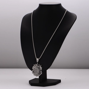 Silver punk crown shield necklace with darts emblem on a black jewelry bust