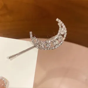 Sparkling silver moon hair clip with rhinestones and star accents for stylish women