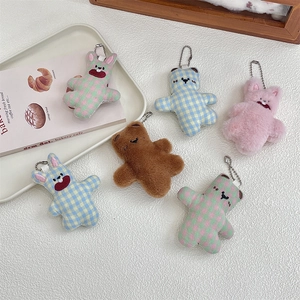 Close-up of 6-piece plush animal charms featuring checkered bears and rabbits with silver chains