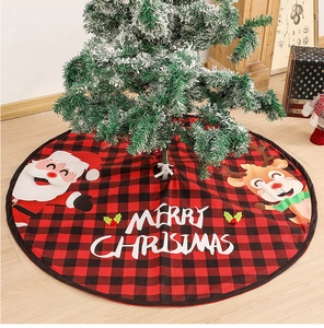 Detail of red buffalo plaid Christmas tree skirt with Santa Claus and reindeer graphics