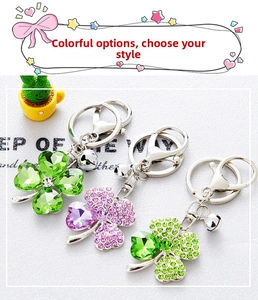 Macro shot of three sparkling rhinestone clover keychains in green and pink finishes