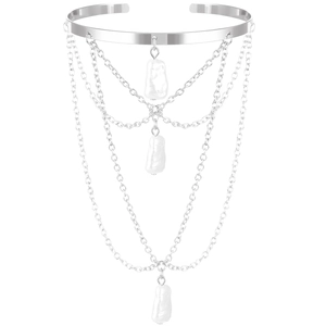 Detail of silver layered chain arm cuff featuring baroque pearls on a white background