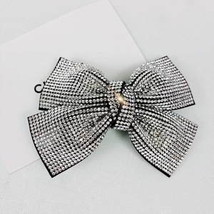 Close-up of sparkling silver rhinestone bow hair clip with high quality crystal detail
