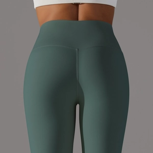 Detail showing high-waisted seamless yoga pants with a V-shaped peach butt lifting seam