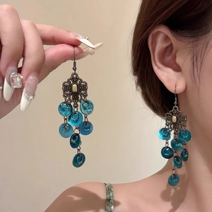 Vintage hollow butterfly tassel earrings with blue sequins and bronze floral accents