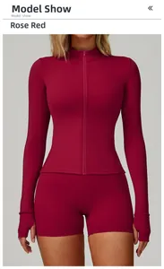 Close-up of rose red zip-up fitness top with thumb holes and matching sports shorts