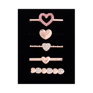 Detail of five rose gold heart-shaped charms and pins for silicone watch straps