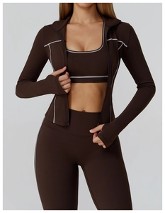 Detail of deep brown yoga set featuring contrast stitching and thumbholes on the sleeves
