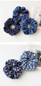 Detailed shot showing denim hair scrunchies with white floral embroidery textures