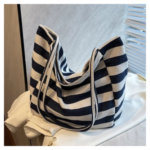 Close-up of durable blue and white striped canvas tote bag with shoulder straps