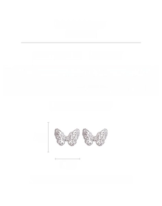 Macro detail of butterfly earrings with micro-inlaid cubic zirconia and silver plating